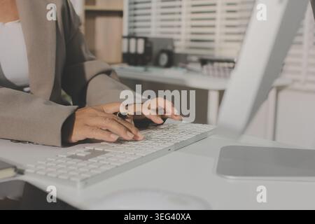 Two young Asian businesswomen discuss investment project working and ...