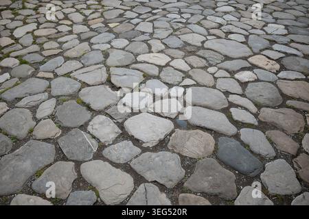 High-angle shot of irregular stone pavers with natural gray tones and weathered textures Stock Photo
