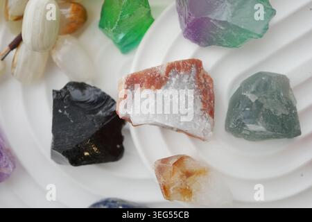 Different types of quartz and minerals on a white display Stock Photo