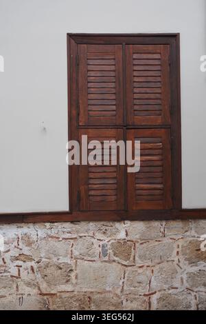 Wooden shutters on a stone wall in a building Stock Photo