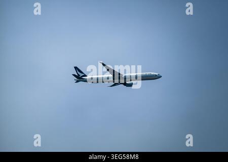 Beijing, China - May 18 2026: Cathay Pacific Boeing 777 passenger airplane flying in the clear sky Stock Photo