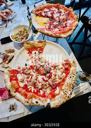 Pizzas on restaurant table Stock Photo