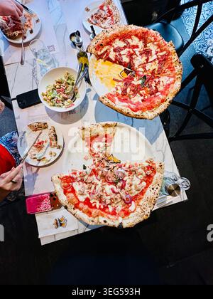 Pizzas on restaurant table Stock Photo