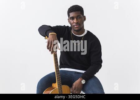 Studio shot of young handsome African man wearing hoodie against white background Stock Photo