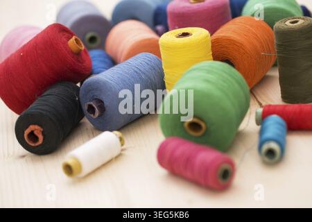 Tailoring. Many colorful threads on the table Stock Photo