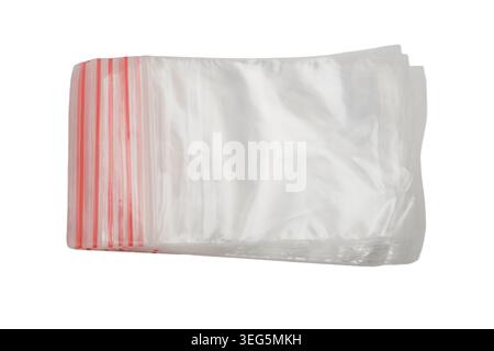 Stack of empty plastic bags with red zipper seals isolated on white background. Transparent resealable storage pouches for organization. Packaging mat Stock Photo