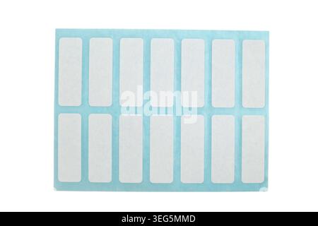 Sheet of blank white rectangular adhesive stickers on blue backing paper. Set of empty self-adhesive labels for organization and price marking. Office Stock Photo