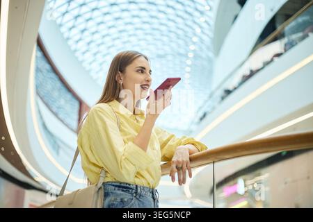 Adult Woman Using Smartphone Voice Message for Mobile Shopping Stock Photo