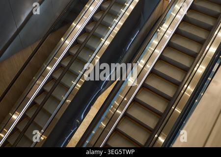 Modern Escalators Operating in Shopping Mall Transit Interior Stock Photo