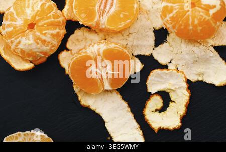 Shelled mandarins on a black background Stock Photo