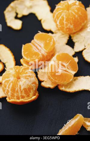 Shelled mandarins on a black background Stock Photo