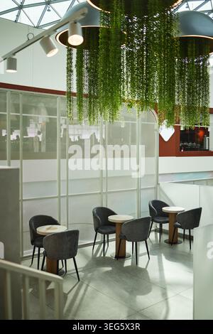 Vertical of Modern Cafe Lounge Featuring Biophilic Design for Workplace Meetings Stock Photo