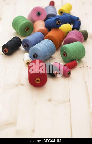 Tailoring. Many colorful threads on the table Stock Photo