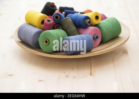 Tailoring. Many colorful threads on the table Stock Photo