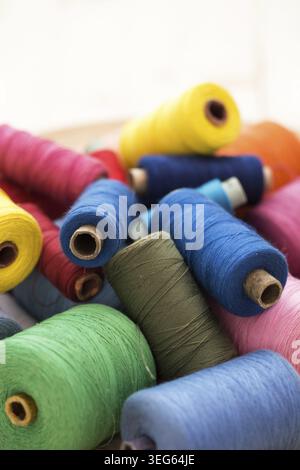 Tailoring. Many colorful threads on the table Stock Photo