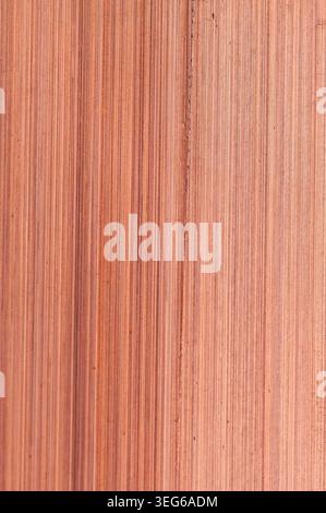 Close-up view of a brushed copper metal surface showcasing its characteristic warm reddish-brown hue and linear texture Stock Photo