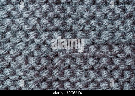 Detailed texture of a woolen textile with visible yarn loops and fibers, showcasing a cozy and warm material Stock Photo