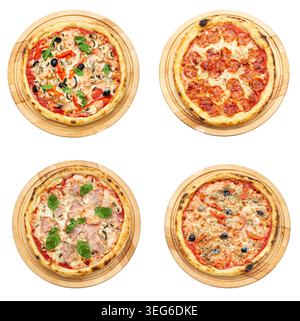 A professional top-view collection of four different pizzas—including pepperoni, vegetarian with mushrooms, and ham with basil—served on round wooden Stock Photo