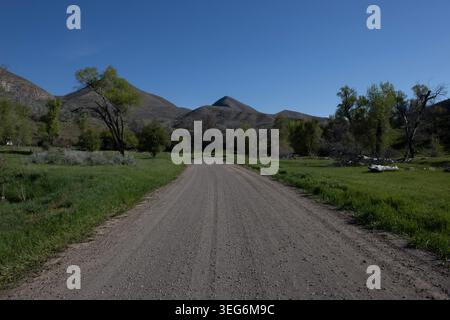 Dirt Road Through Green Mountain Valley Stock Photo