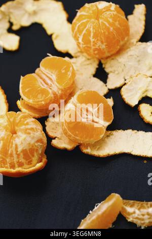 Shelled mandarins on a black background Stock Photo