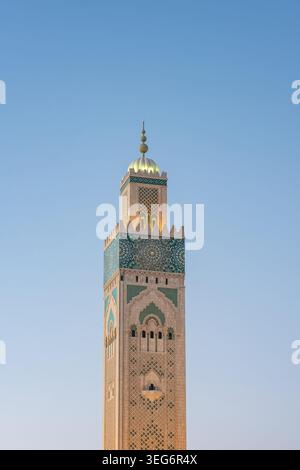 Ornate minaret of Hassan II Mosque at twilight in Casablanca, Morocco Stock Photo