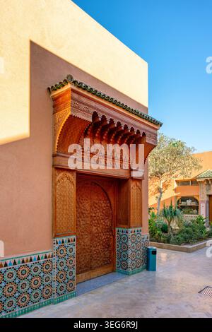 Intricate carved wooden door in a Moroccan courtyard in Marrakesh Stock Photo