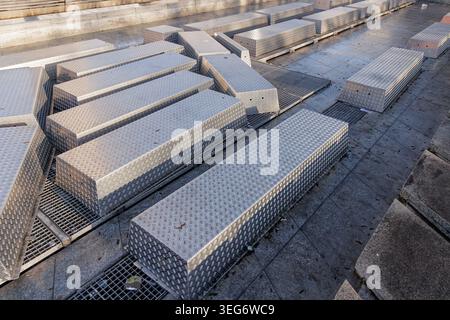 Long metal boxes with diamond plate texture outdoors Stock Photo
