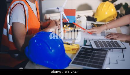 Two technicians inspect server racks in data center with tablet and fiber optic cable. Engineer and specialist discuss maintenance work in data center Stock Photo