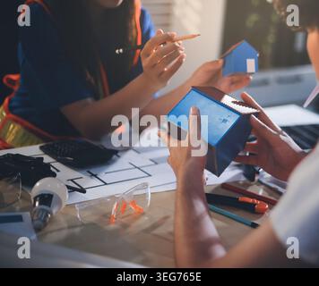 Two technicians inspect server racks in data center with tablet and fiber optic cable. Engineer and specialist discuss maintenance work in data center Stock Photo
