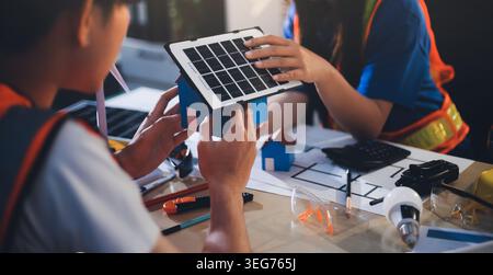 Two technicians inspect server racks in data center with tablet and fiber optic cable. Engineer and specialist discuss maintenance work in data center Stock Photo