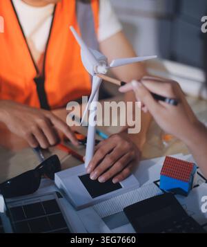 Two technicians inspect server racks in data center with tablet and fiber optic cable. Engineer and specialist discuss maintenance work in data center Stock Photo