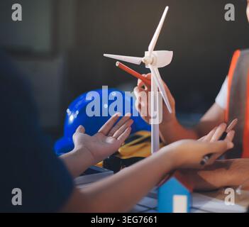 Two technicians inspect server racks in data center with tablet and fiber optic cable. Engineer and specialist discuss maintenance work in data center Stock Photo