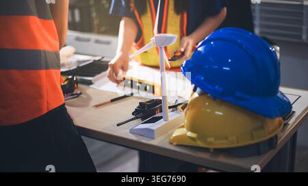 Two technicians inspect server racks in data center with tablet and fiber optic cable. Engineer and specialist discuss maintenance work in data center Stock Photo