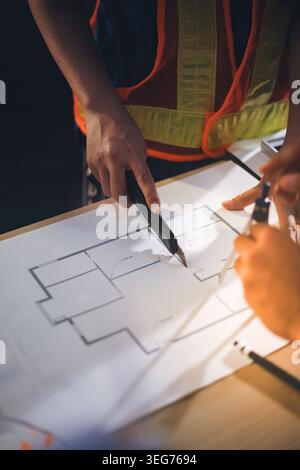 Two technicians inspect server racks in data center with tablet and fiber optic cable. Engineer and specialist discuss maintenance work in data center Stock Photo