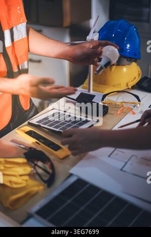 Two technicians inspect server racks in data center with tablet and fiber optic cable. Engineer and specialist discuss maintenance work in data center Stock Photo