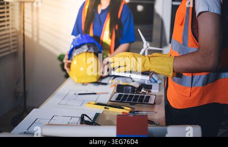 Two technicians inspect server racks in data center with tablet and fiber optic cable. Engineer and specialist discuss maintenance work in data center Stock Photo