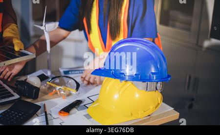 Two technicians inspect server racks in data center with tablet and fiber optic cable. Engineer and specialist discuss maintenance work in data center Stock Photo