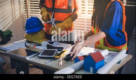 Two technicians inspect server racks in data center with tablet and fiber optic cable. Engineer and specialist discuss maintenance work in data center Stock Photo