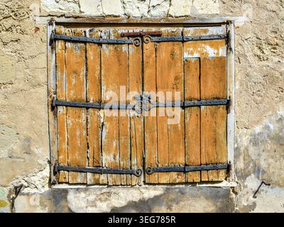 Pair of closed, old wooden window shutters - Beaulieu-les-Loches, Indre-et-Loire (37), France. Stock Photo