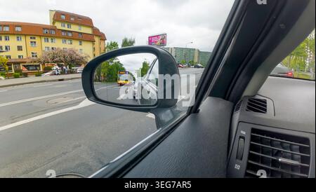Driving car, rear view in side mirror. Traffic in Poland. Stock Photo