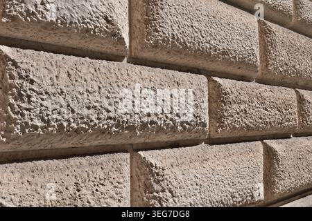 BACKGROUND TEXTURE OF A WALL WITH STONE BLOCK CLADDING Stock Photo