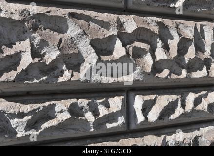 BACKGROUND TEXTURE OF A WALL WITH STONE BLOCK CLADDING Stock Photo