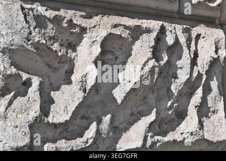BACKGROUND TEXTURE OF A WALL WITH STONE BLOCK CLADDING Stock Photo
