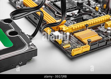 Hard drive connected to a computer motherboard. Stock Photo