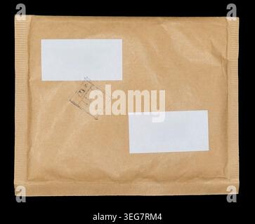 Brown paper padded envelope mailer with white labels and ink stamp. Stock Photo