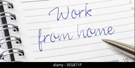 Work from home written on a calendar page Stock Photo