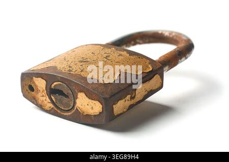 old weathered rusty iron padlock with peeling gold paint and empty keyhole isolated white background, soft focus with shadow Stock Photo