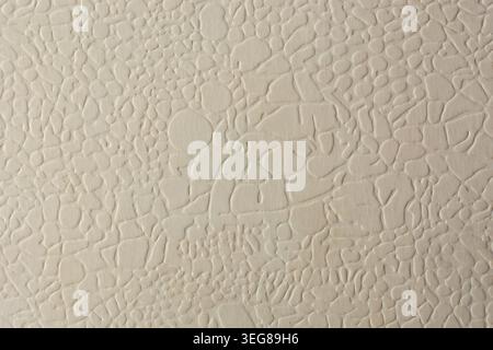 light cream embossed paper surface, raised irregular pebble pattern with matte finish, full frame background, graphic design backdrop texture Stock Photo