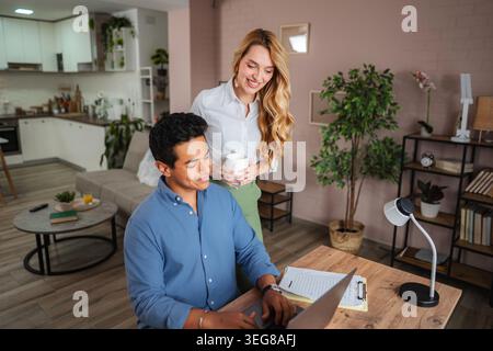 Young couple collaborating creating good teamwork at home office Stock Photo