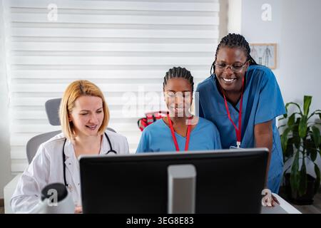 Diverse medical team collaborating on digital healthcare solutions Stock Photo
